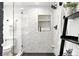 Contemporary bathroom featuring a glass-enclosed shower with marble-style tiling, and modern fixtures at 4968 Alcott St, Denver, CO 80221