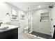 Modern bathroom featuring a sleek glass shower with stylish marble-like tiles, and modern fixtures at 4968 Alcott St, Denver, CO 80221