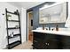Stylish bathroom featuring a large mirror, marble countertop vanity, and glass-enclosed shower at 4968 Alcott St, Denver, CO 80221