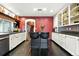 Lovely kitchen featuring stainless steel appliances, dark wood flooring, a red brick wall and granite countertops at 4968 Alcott St, Denver, CO 80221