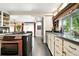 Well-appointed kitchen featuring stainless steel appliances, granite countertops, and dark wood flooring at 4968 Alcott St, Denver, CO 80221