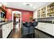 Beautiful kitchen with painted brick, modern appliances, ample counter space, and wood flooring at 4968 Alcott St, Denver, CO 80221
