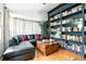 Stylish living room with a built-in bookcase and comfortable seating arrangement at 4968 Alcott St, Denver, CO 80221