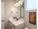 Well-lit bathroom with a vanity and modern mirror at 9843 Rosalee Peak St, Littleton, CO 80125