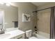 Well-lit bathroom featuring a shower-tub combo with tile surround and modern vanity at 9843 Rosalee Peak St, Littleton, CO 80125