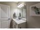 Bright bathroom featuring a modern vanity with mirror and stylish lighting at 9843 Rosalee Peak St, Littleton, CO 80125