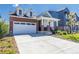 Charming brick-and-siding home with a two-car garage and covered front porch, landscaped for great curb appeal at 9843 Rosalee Peak St, Littleton, CO 80125
