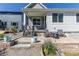 Charming home featuring a front patio with seating and beautiful landscaping at 9843 Rosalee Peak St, Littleton, CO 80125