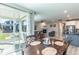 Open concept living room with fireplace and dining area, and access to the outdoor patio at 9843 Rosalee Peak St, Littleton, CO 80125