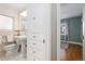 Bathroom with pedestal sink, toilet and linen closet at 1545 Newport St, Denver, CO 80220