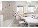 Clean bathroom, featuring a bathtub, toilet and sink at 1545 Newport St, Denver, CO 80220