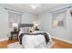 Bedroom with queen bed, light blue walls and wood floors at 1545 Newport St, Denver, CO 80220