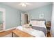 Bedroom with queen bed, light blue walls and wood floors at 1545 Newport St, Denver, CO 80220