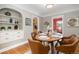 Bright dining room features a wood table with leather chairs, built-in shelving, and hardwood floors at 1545 Newport St, Denver, CO 80220