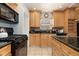 Modern kitchen with granite countertops and light wood cabinets at 1545 Newport St, Denver, CO 80220