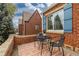 Small patio with brick wall and seating at 1545 Newport St, Denver, CO 80220