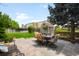 Paved backyard patio includes an outdoor dining area and a storage shed at 19716 Glendale Ln, Parker, CO 80134