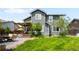 View of the home's backyard featuring a covered patio, lush green lawn, and mature trees at 19716 Glendale Ln, Parker, CO 80134