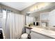 Well-lit bathroom featuring a shower/tub combo and a vanity with ample storage at 19716 Glendale Ln, Parker, CO 80134