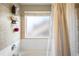 Shower and window feature neutral tiling, allowing natural light in this bright, clean bathroom at 19716 Glendale Ln, Parker, CO 80134