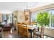 Bright dining room with wooden table set and large windows overlooking the garden at 19716 Glendale Ln, Parker, CO 80134