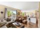 Open-concept living room with hardwood floors flowing into a dining area, providing a great space for Gathering gatherings at 19716 Glendale Ln, Parker, CO 80134