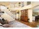 Open-concept living room featuring high ceilings, a staircase, and a decorative china cabinet at 19716 Glendale Ln, Parker, CO 80134