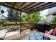 Covered patio area complete with outdoor furniture, a grill, and decorative hanging plants at 19716 Glendale Ln, Parker, CO 80134