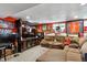 Basement Gathering room featuring a large sectional sofa, TV, and sports memorabilia on the walls at 6409 Brentwood St, Arvada, CO 80004