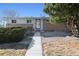 Charming single-story home with a well-maintained front yard and a welcoming walkway, in a quiet neighborhood at 6409 Brentwood St, Arvada, CO 80004