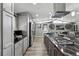 Modern kitchen with stainless steel appliances, a large island, and ample counter space for cooking and entertaining at 6409 Brentwood St, Arvada, CO 80004