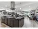 Open concept kitchen and living area with a large island, stainless steel appliances, and modern finishes at 6409 Brentwood St, Arvada, CO 80004