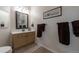 Clean and functional bathroom featuring a vanity and neutral-colored tiles at 8338 S Independence Cir # 108, Littleton, CO 80128