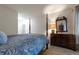 Spacious bedroom featuring a four-poster bed, dresser, and a decorative mirror at 8338 S Independence Cir # 108, Littleton, CO 80128