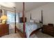 Comfortable bedroom with natural light and classic four poster bed at 8338 S Independence Cir # 108, Littleton, CO 80128