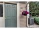 Inviting entryway with a green door and decorative hanging flower basket at 8338 S Independence Cir # 108, Littleton, CO 80128
