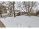 Two-story house with brick and siding exterior, attached garage, and snowy front yard, RV parking at 15064 E Floyd Ave, Aurora, CO 80014