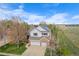 Aerial view of home with solar panels, three-car garage, and expansive lawn backing to open space at 13804 Quail Ridge Dr, Broomfield, CO 80020