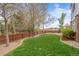 Beautiful backyard featuring a lush lawn, stone patio, privacy fence, and mature trees at 13804 Quail Ridge Dr, Broomfield, CO 80020