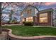 Large backyard with a stone patio area, lush lawn, and mature trees, perfect for outdoor enjoyment at 13804 Quail Ridge Dr, Broomfield, CO 80020