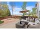 Enjoy outdoor living on the stone patio, featuring a dining set and lounge area at 13804 Quail Ridge Dr, Broomfield, CO 80020