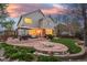 Spacious backyard oasis with a stone patio, built-in fire pit, and beautifully landscaped garden at 13804 Quail Ridge Dr, Broomfield, CO 80020