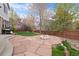 Serene backyard features a large stone patio and lush lawn, ideal for outdoor activities and relaxation at 13804 Quail Ridge Dr, Broomfield, CO 80020