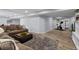 Finished basement area features wood-look floors, comfortable seating, and a dedicated workout space at 13804 Quail Ridge Dr, Broomfield, CO 80020
