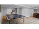 Finished basement area with a ping pong table and ample space for recreation and leisure activities at 13804 Quail Ridge Dr, Broomfield, CO 80020