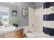 Well-lit bathroom with a wood vanity, shower-tub combo, and decorative accents at 13804 Quail Ridge Dr, Broomfield, CO 80020