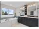Bright bathroom featuring a soaking tub under a large window and double vanity with modern fixtures at 13804 Quail Ridge Dr, Broomfield, CO 80020