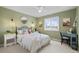 Green bedroom with an iron bed frame, modern decor, and natural light from a window at 13804 Quail Ridge Dr, Broomfield, CO 80020