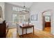 Elegant dining area with a modern chandelier, large windows, and stylish decor at 13804 Quail Ridge Dr, Broomfield, CO 80020
