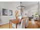 Elegant dining room with hardwood floors, view into kitchen and a staircase with iron railing at 13804 Quail Ridge Dr, Broomfield, CO 80020